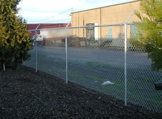 Galvanized chain link security fence around a commercial lot